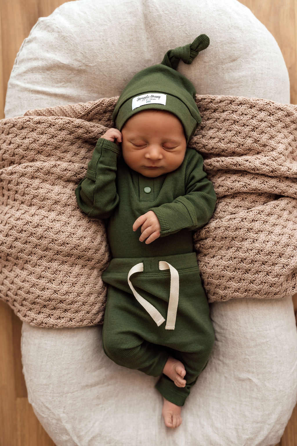 Olive long sleeve bodysuit paired with olive pants & beanie