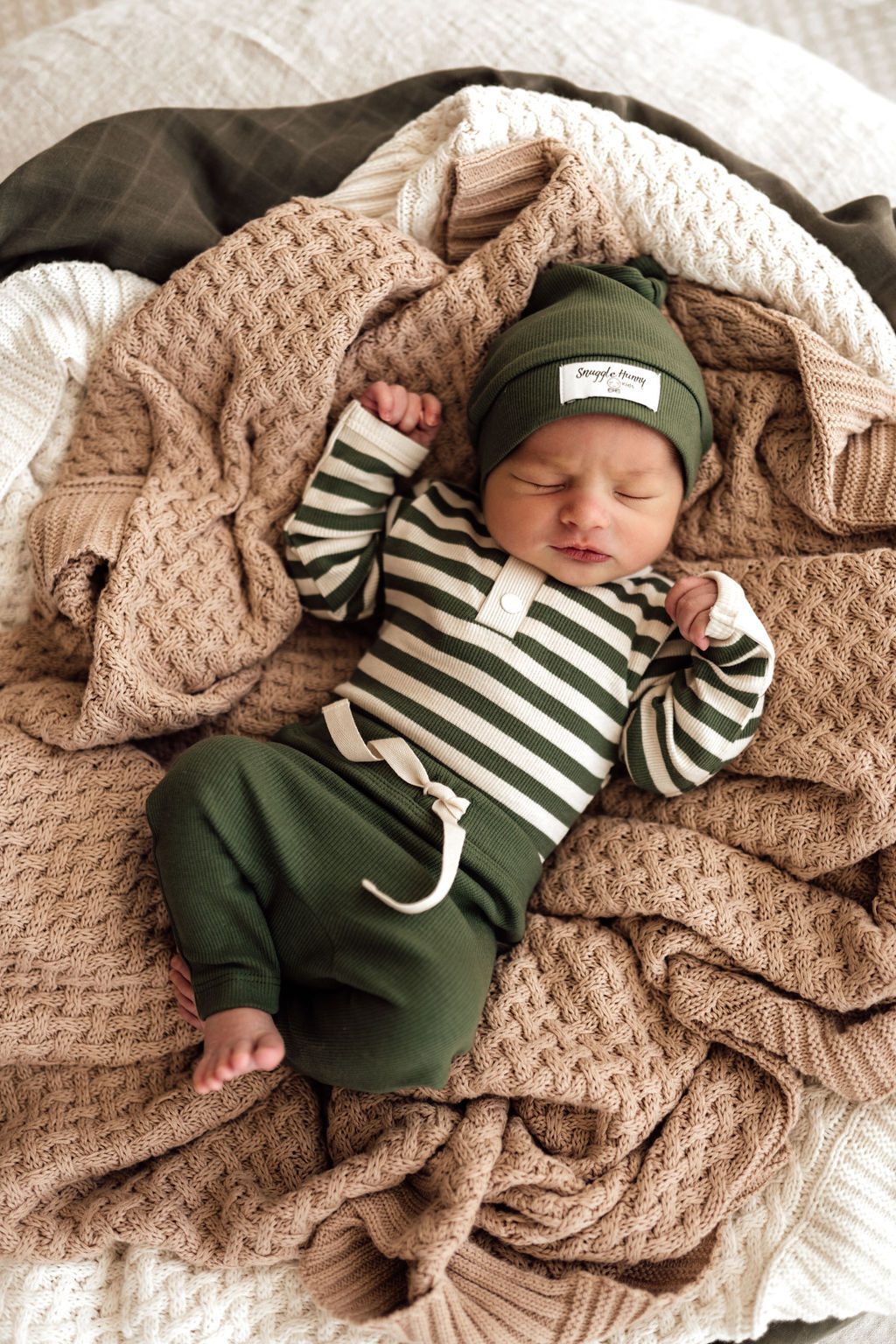 Baby dressed in Olive stripe bodysuit in stretch rib, paired with olive pants