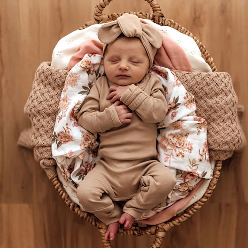 Baby shown in beautiful neutral Pebble colour growsuit