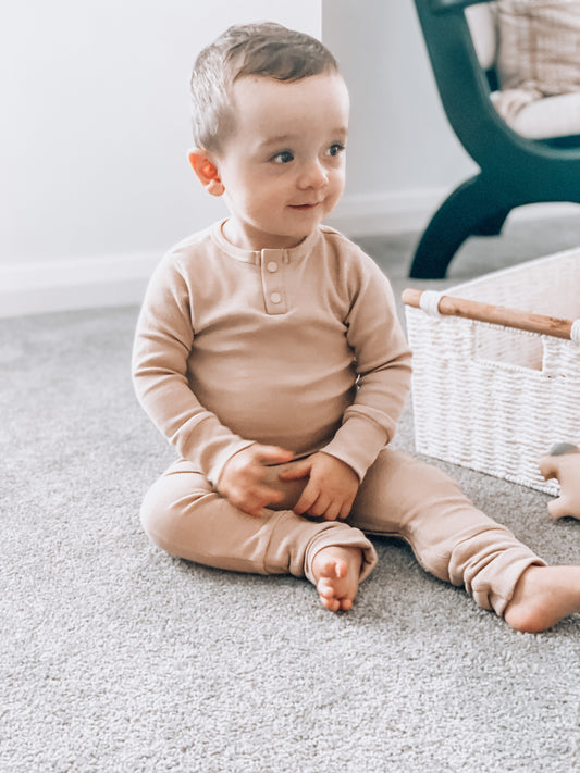 Toddler shown in beautiful neutral Pebble colour growsuit