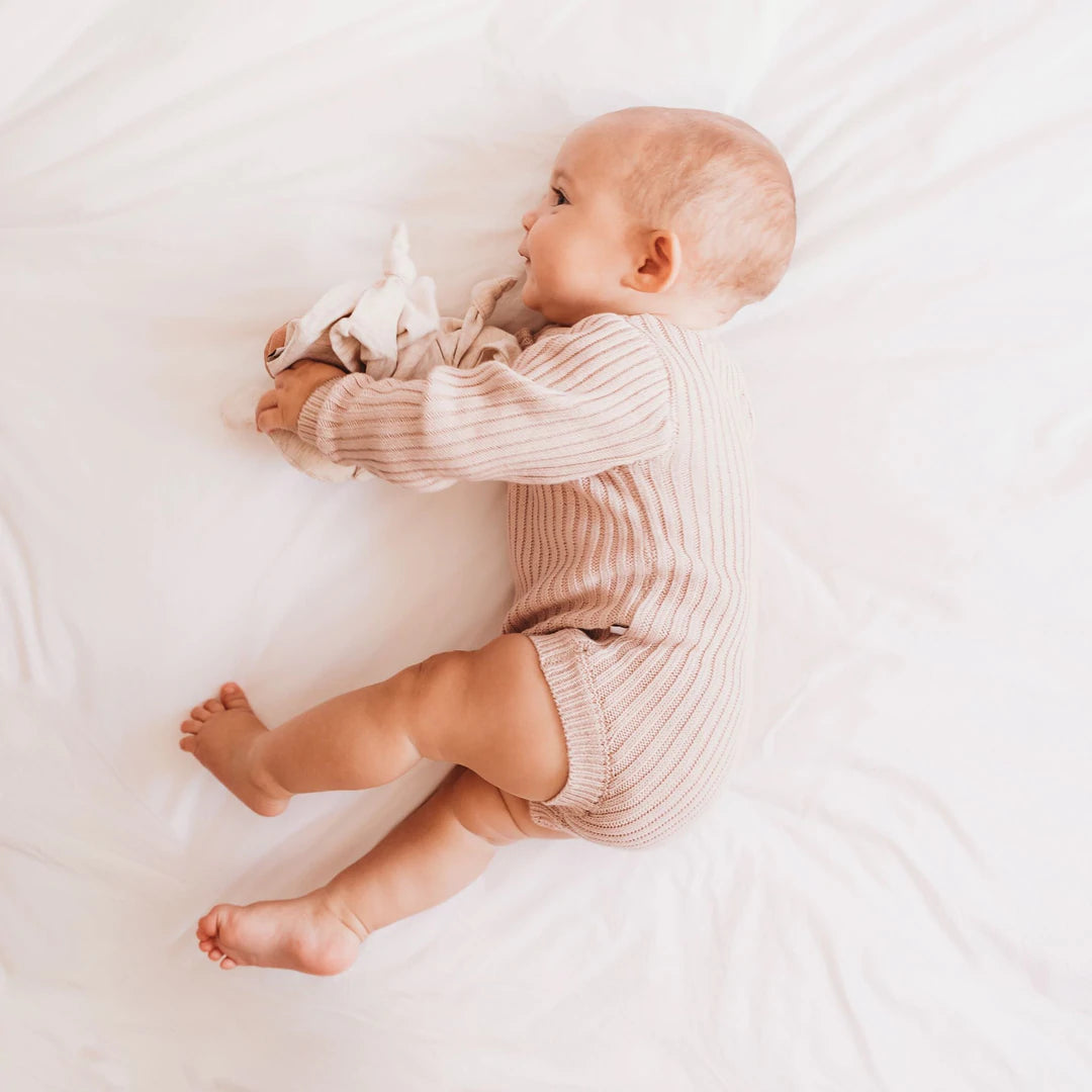 Soft bamboo rib knit baby long sleeve bodysuit in a soft pink colour.