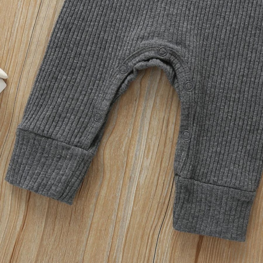 Lower half of the grey jumpsuit showing button up from Ankle to Ankle for easy nappy changes