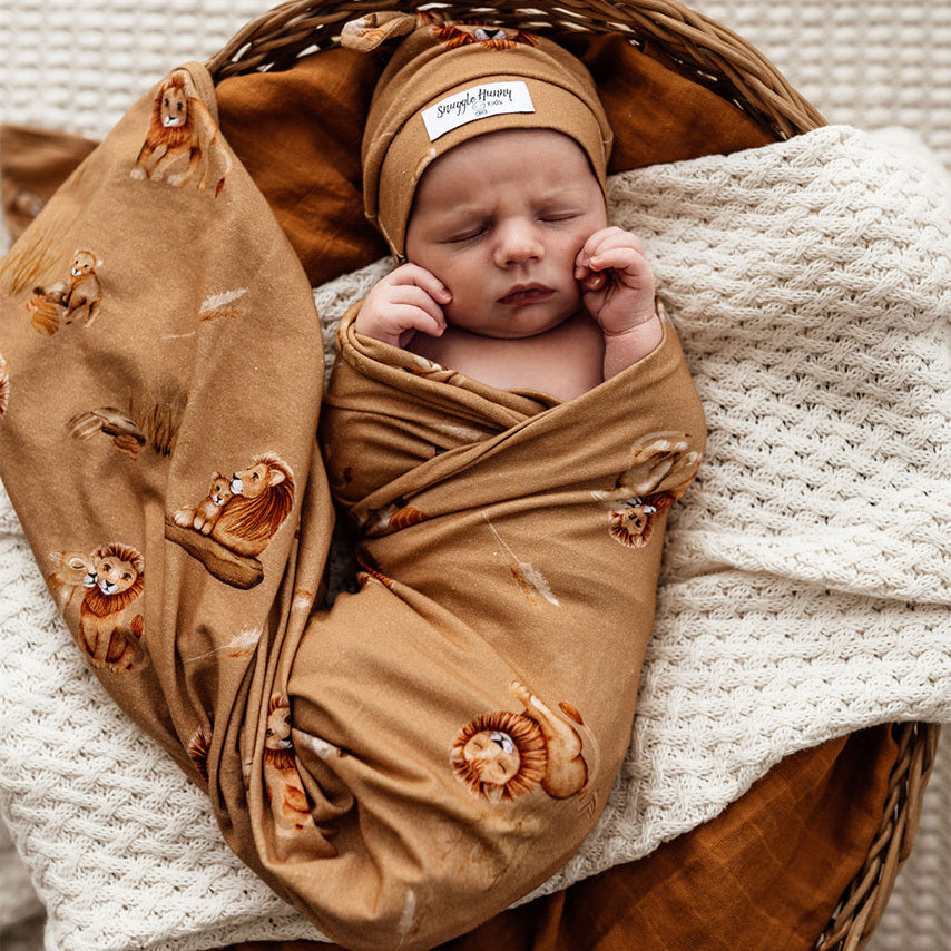 Gorgeous bub wrapped in a caramel colour Jersey wrap in the lion design.