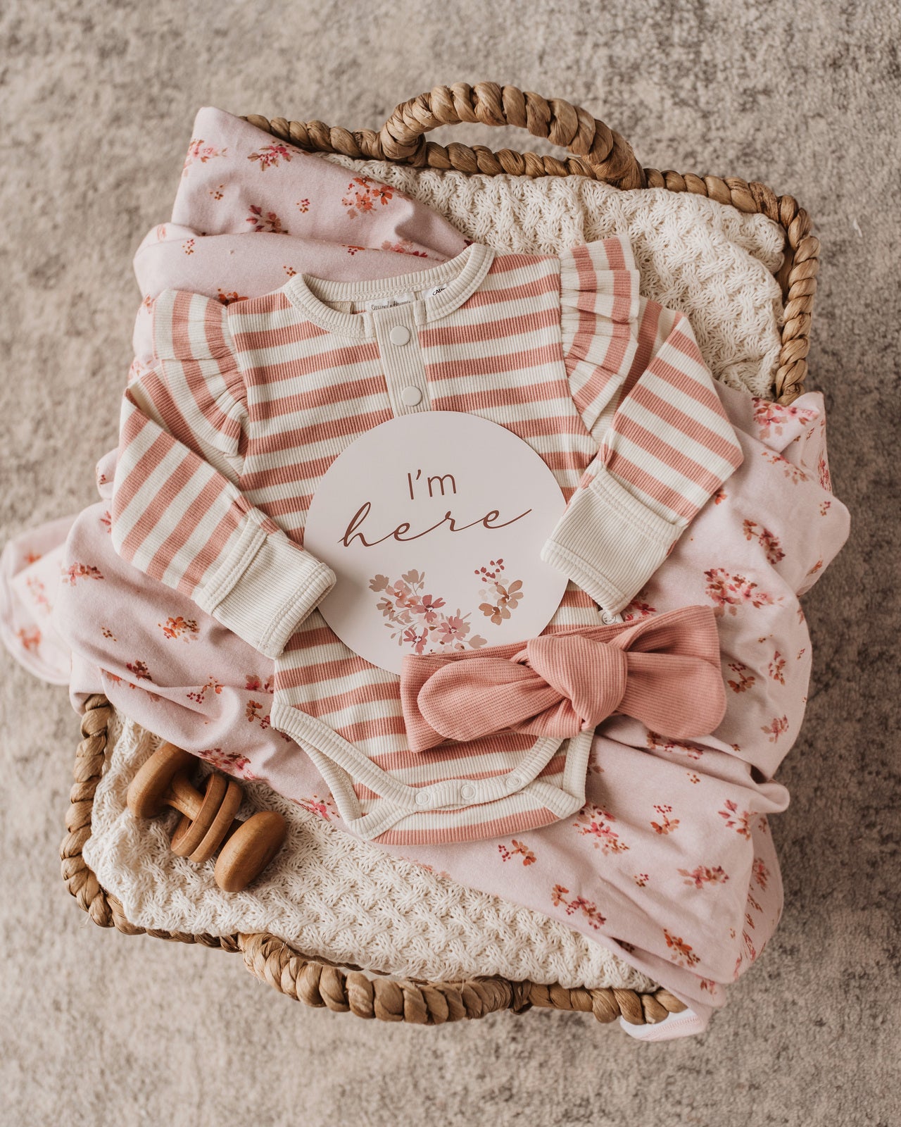 Featured rose stripe bodysuit with the rose milestone card 'i'm here' & rose bow