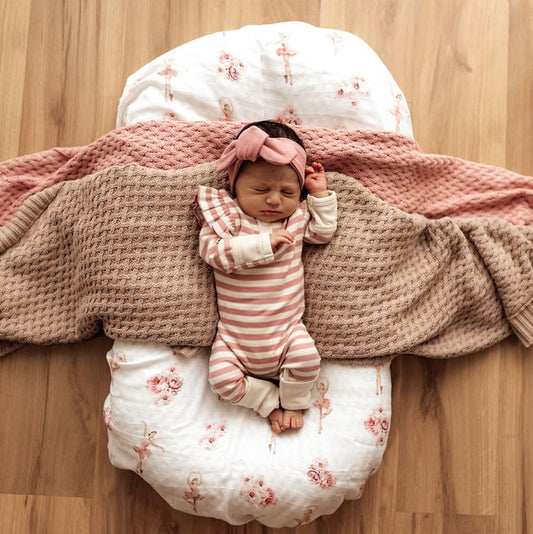 Newborn dressed in the beautiful rose stripe growsuit, with small frills on the shoulders. Finished with a rose coloured top knot.