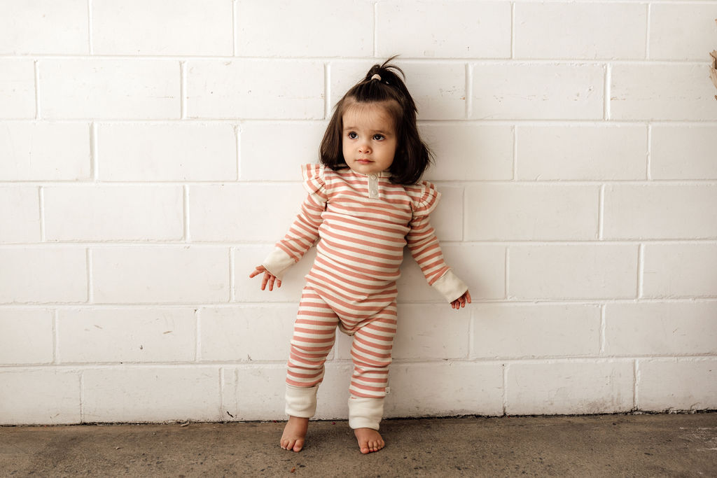 toddler wearing the rose stripe growsuit in stretch rib fabric, foldable hand & foot mittens